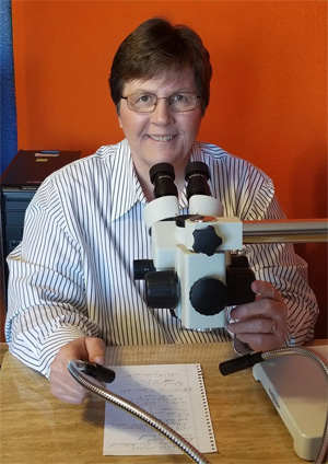Jan Seaman Kelly lady examining document